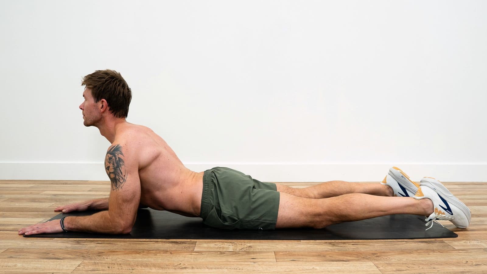 Dan lying face down, propped up on his forearms with his chest lifted